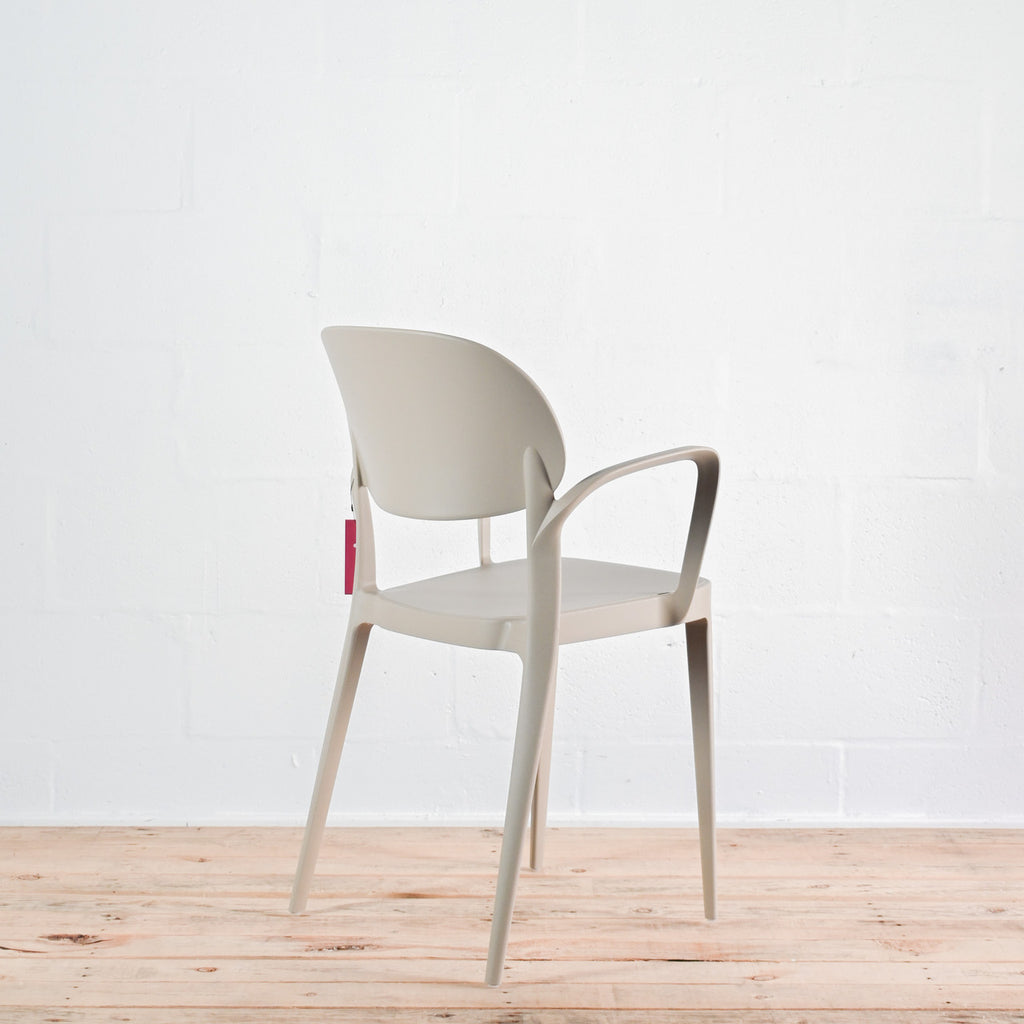 Side view of Alma Amy stacking chair in Sand