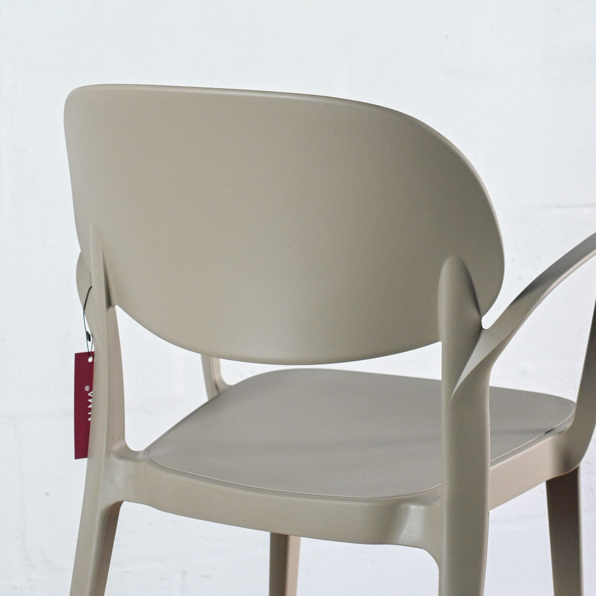 Close-up of rear view of Alma Amy stacking chair in Sand
